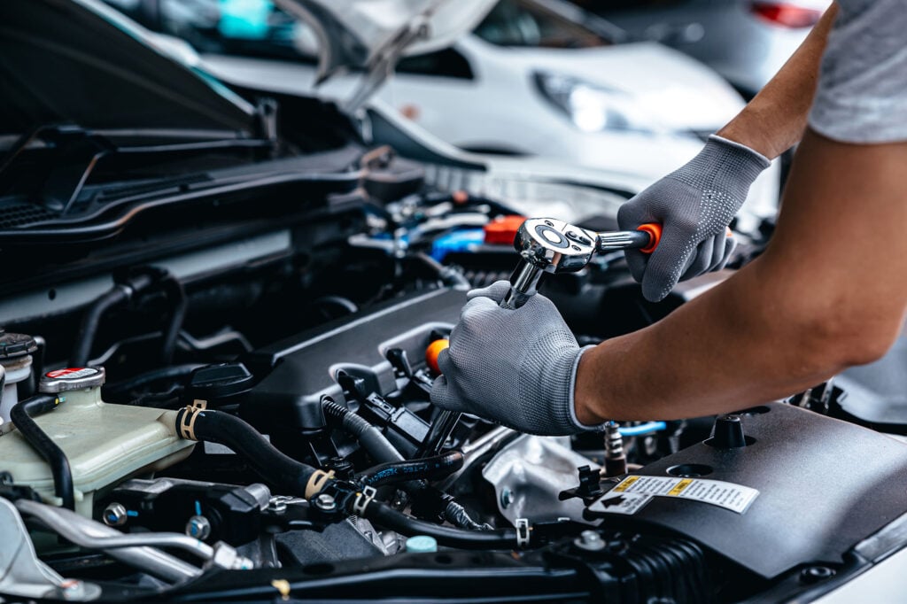 auto mechanic servicing a car engine at Gosford Windscreens