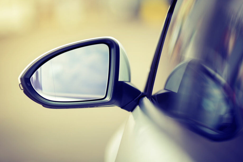 Close-up of a car side mirror reflecting light at Gosford Windscreens.