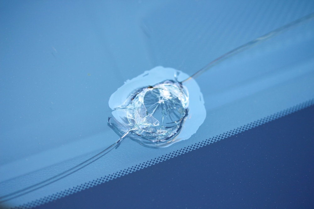 Close-up of a chipped car windscreen showing cracked glass at Gosford Windscreens.
